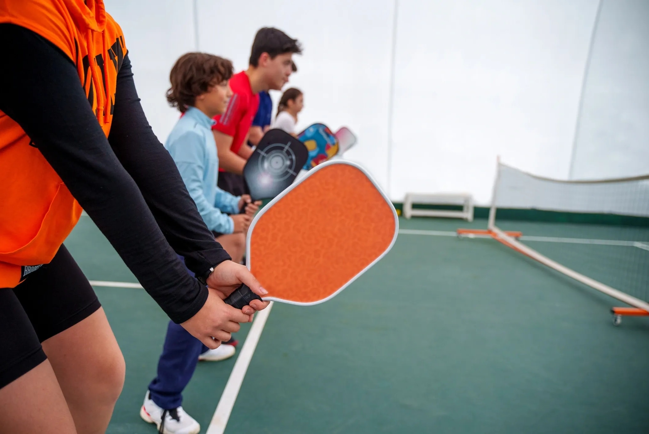 Pickleball instructor coaching a player on the court